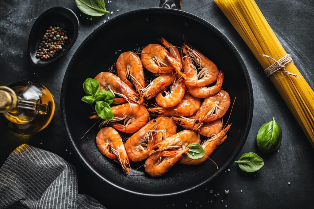 Fried shrimps with spices on pan